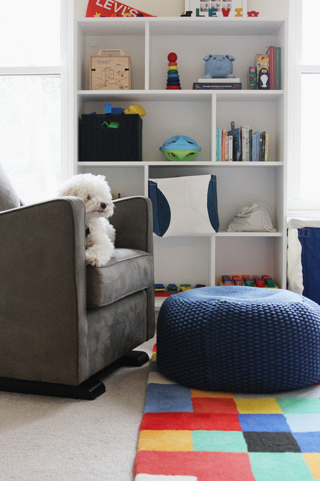 IKEA bookcase, Monte glider, and The Land of Nod poof in a boys' shared bedroom