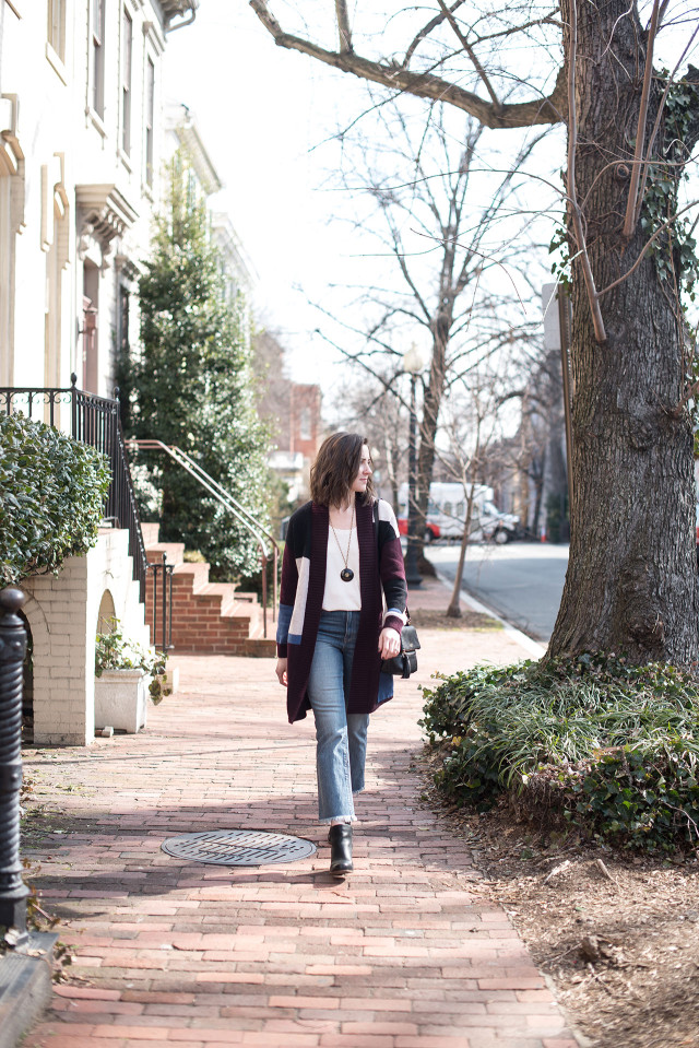 An early spring outfit: high-rise, frayed-hem cropped flare jeans with a sweater cardigan and wedge boots