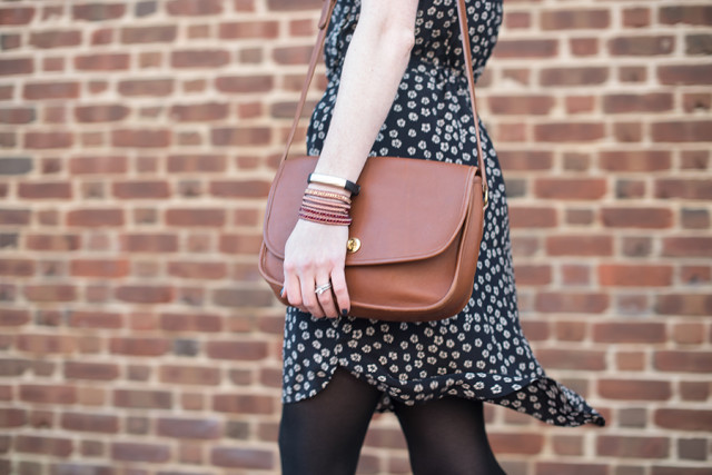 Wearing a Nakamol wrap bracelet and a vintage Coach turnlock purse with a floral spring dress from Madewell
