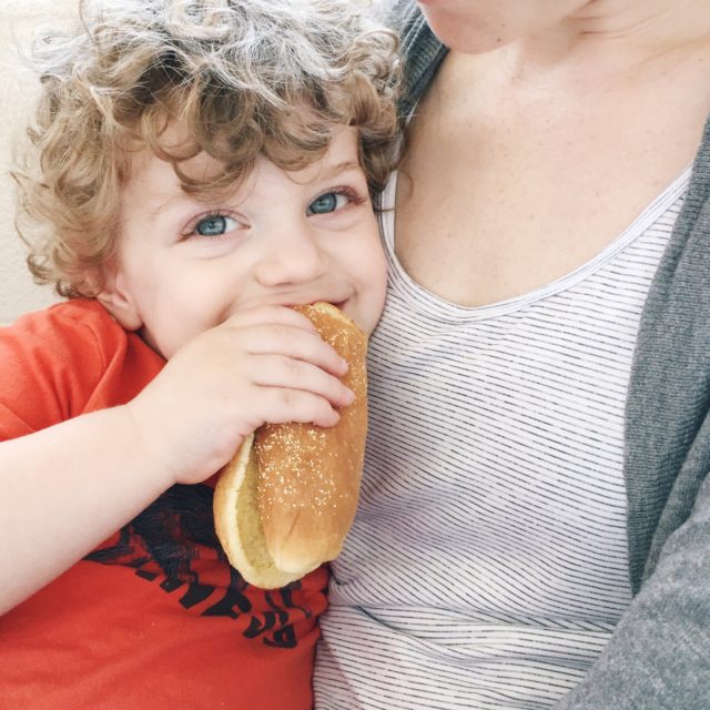Toddler eating hot dog bun